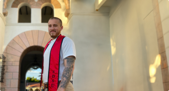 jake standing in front of an archway wearing a stole